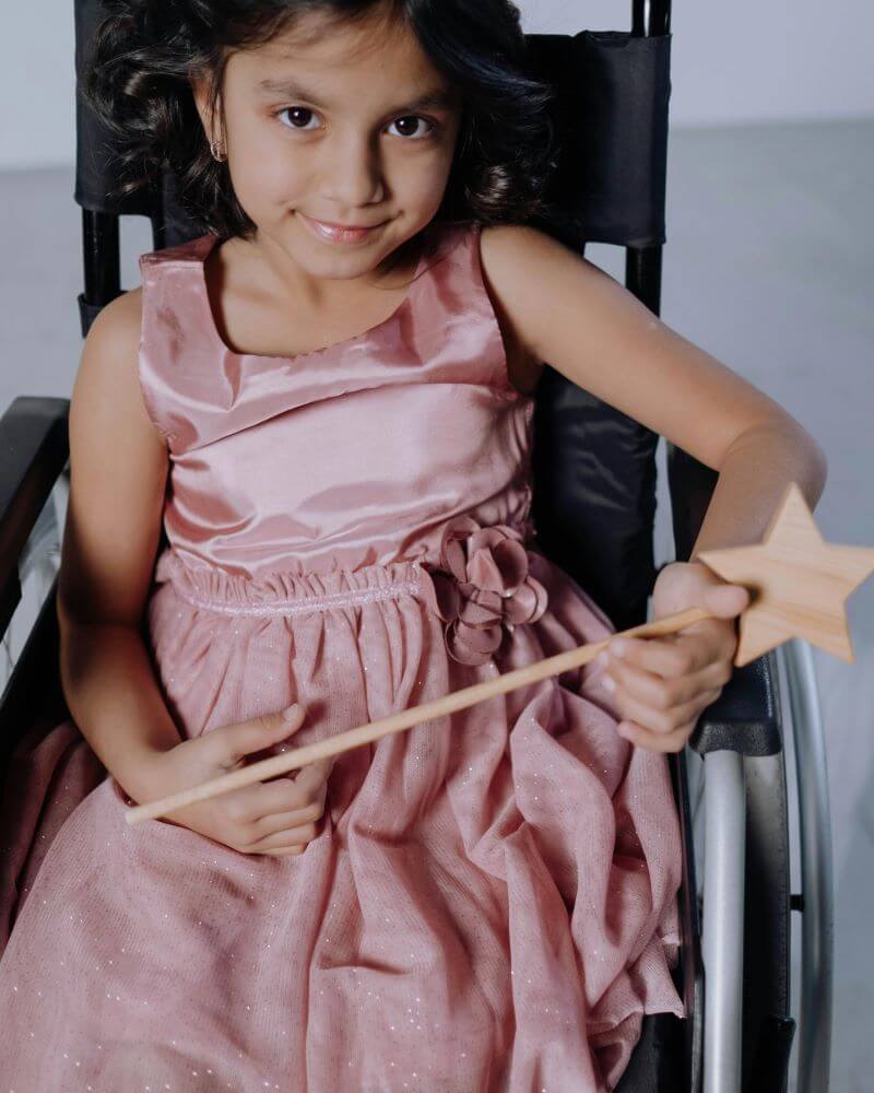 pexels-cottonbro-6191131 (1) A Girl in Pink Dress Sitting on Wheelchair<br />